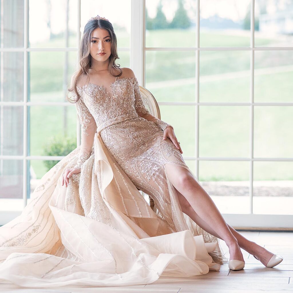 Evelina sitting in her custom wedding gown