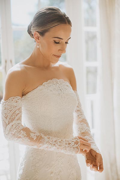 Jessica posing in her wedding dress with detachable sleeves