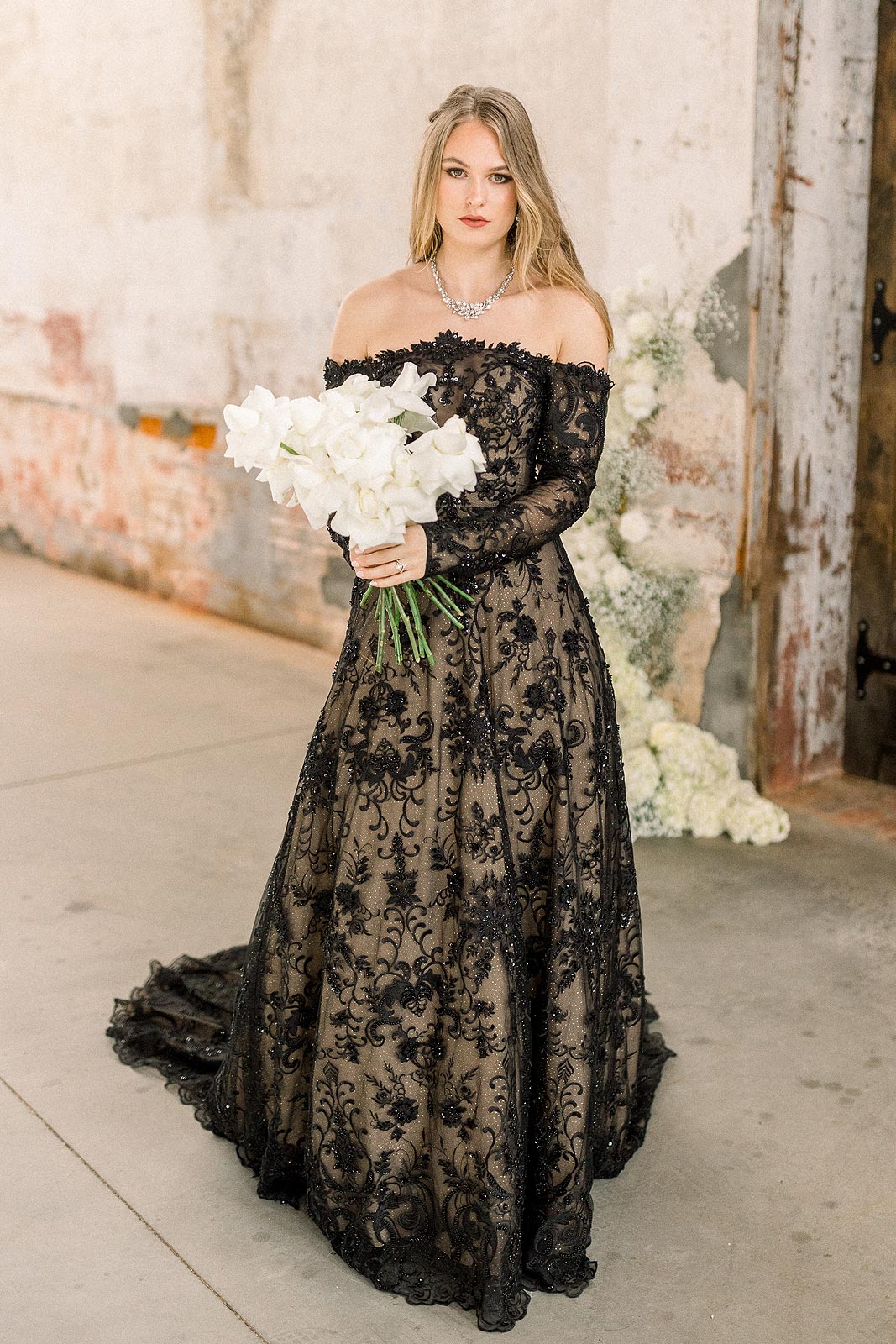 Payton holding a bouquet in her black bridal gown