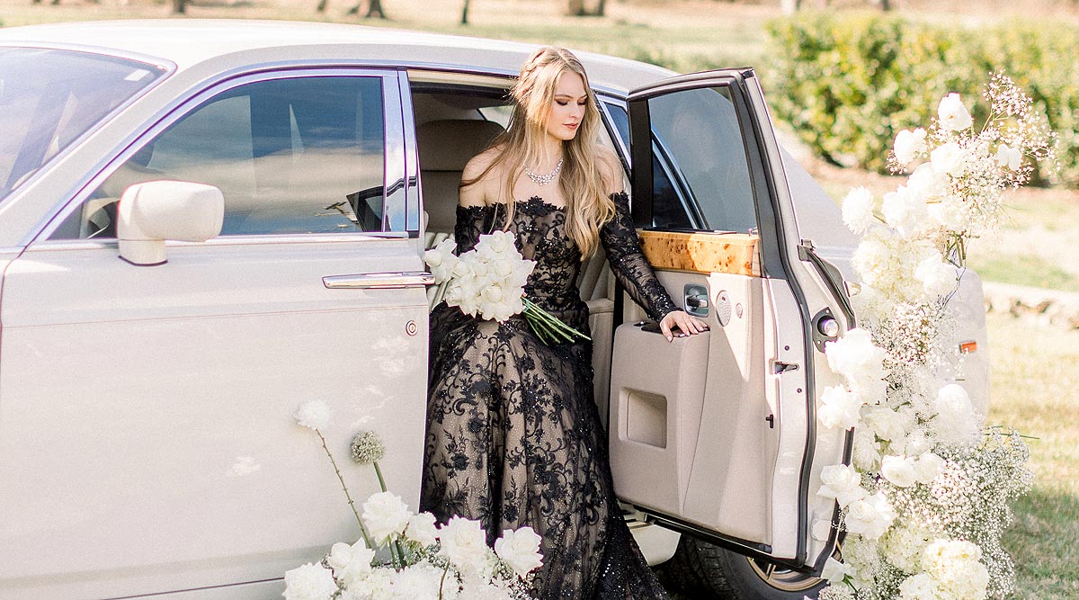Payton wearing a black wedding dress in a white limo