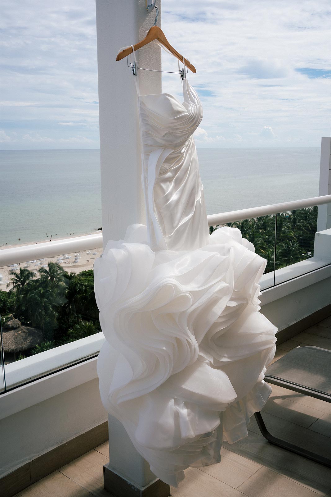 Chelsea's custom wedding dress on a hanger