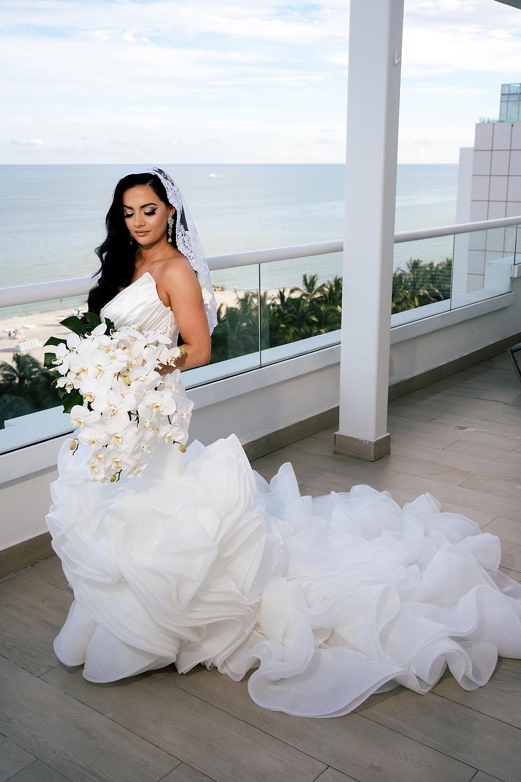 Chelsea in her wedding dress on a deck