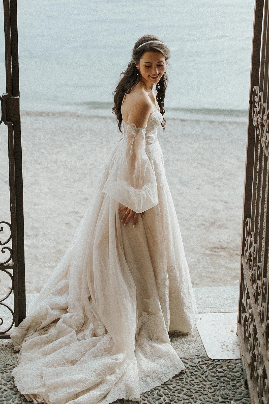 Morgan standing by the beach in her wedding dress